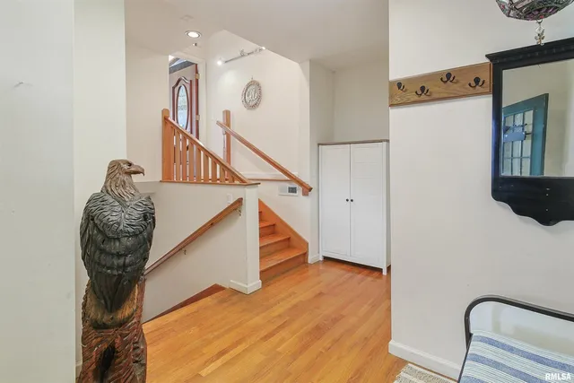 a view of entryway and hall with wooden floor