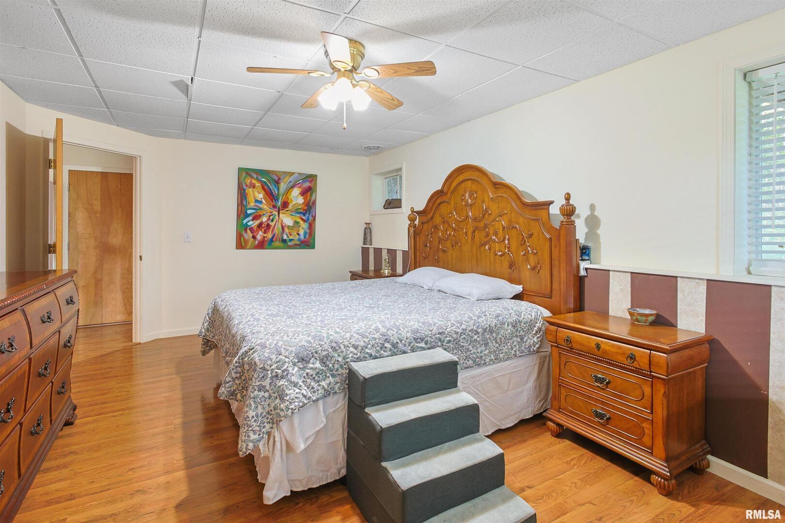 2115 North Lick Creek Road Goreville, IL 62939 - Photo 21 of 28 a bedroom with a bed and a chandelier