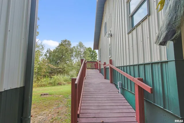 a view of balcony with wooden floor and fence