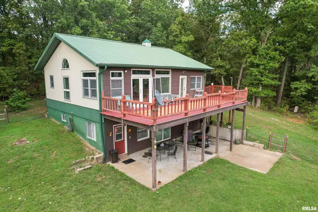 a view of a house with a yard porch and sitting area