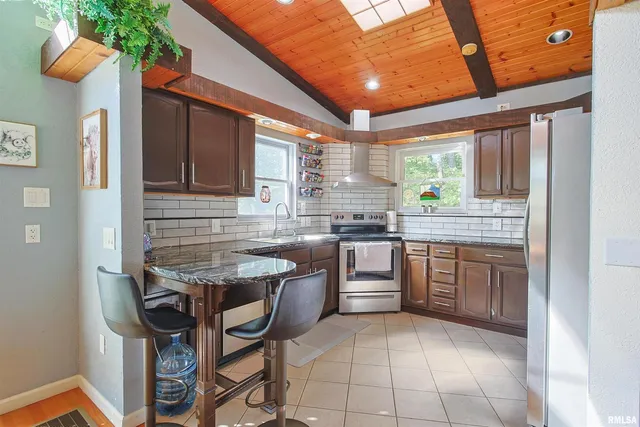 a kitchen with a sink a table and chairs