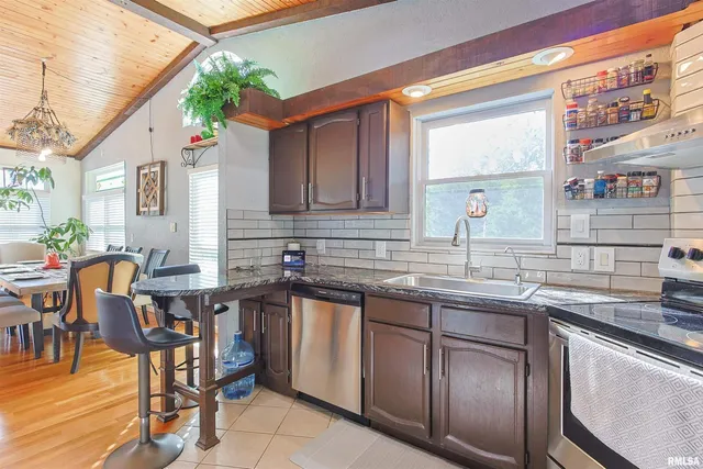 a kitchen with a sink window and cabinets