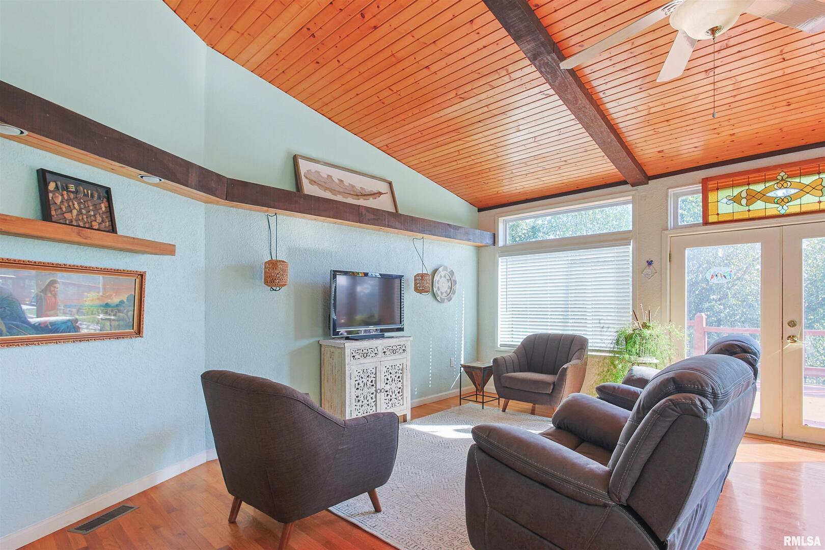 2115 North Lick Creek Road Goreville, IL 62939 - Photo 7 of 28 a living room with furniture a fireplace and a flat screen tv