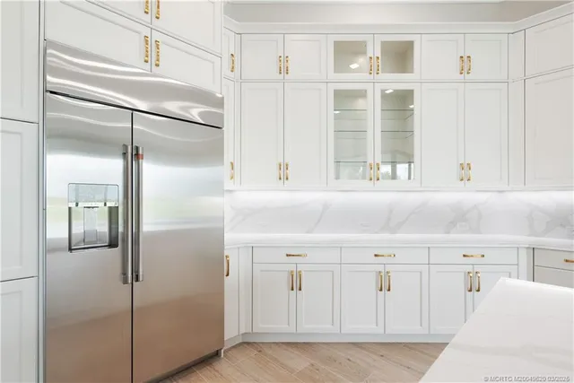 a large white kitchen with a large window
