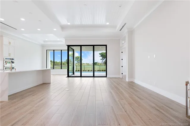 a front view of a house with garden and plants