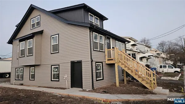 a front view of a house with large windows