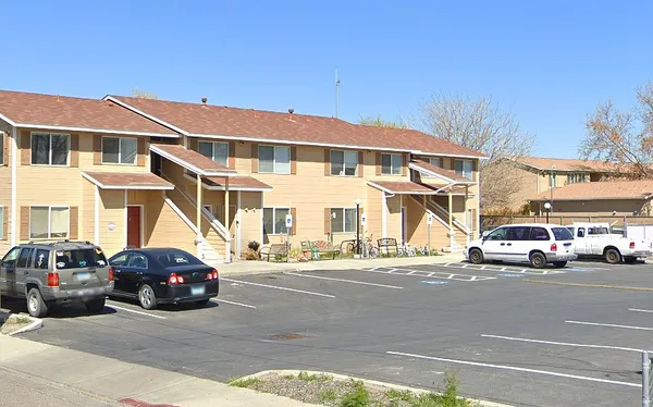 a cars parked in front of a white building