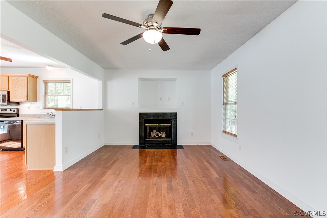 112 Loomis Road Aylett, VA 23009 - Photo 8 of 50 a view of empty room with wooden floor and fan