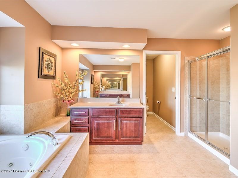 14 Hanging Rock Road Freehold, NJ 07728 - Photo 22 of 32 a spacious bathroom with a tub sink and mirror