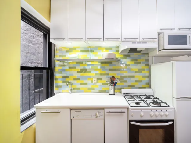 a kitchen with stainless steel appliances kitchen island granite countertop a stove and a refrigerator