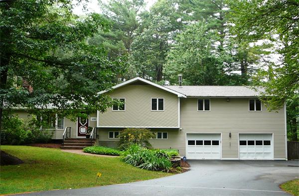 499 Dutton Road Sudbury, MA 01776 - Photo 1 of 21 a front view of a house with a garden