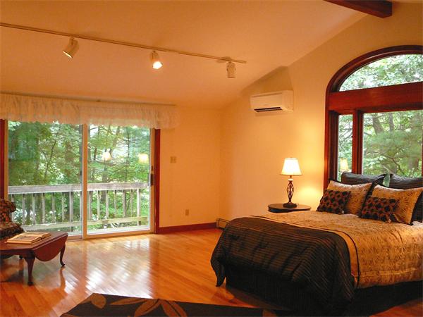 499 Dutton Road Sudbury, MA 01776 - Photo 12 of 21 a bedroom with a bed and a large window