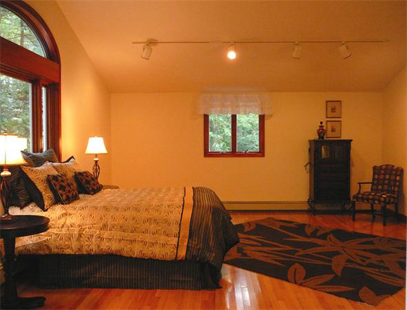 499 Dutton Road Sudbury, MA 01776 - Photo 13 of 21 a bedroom with a bed and wooden floor