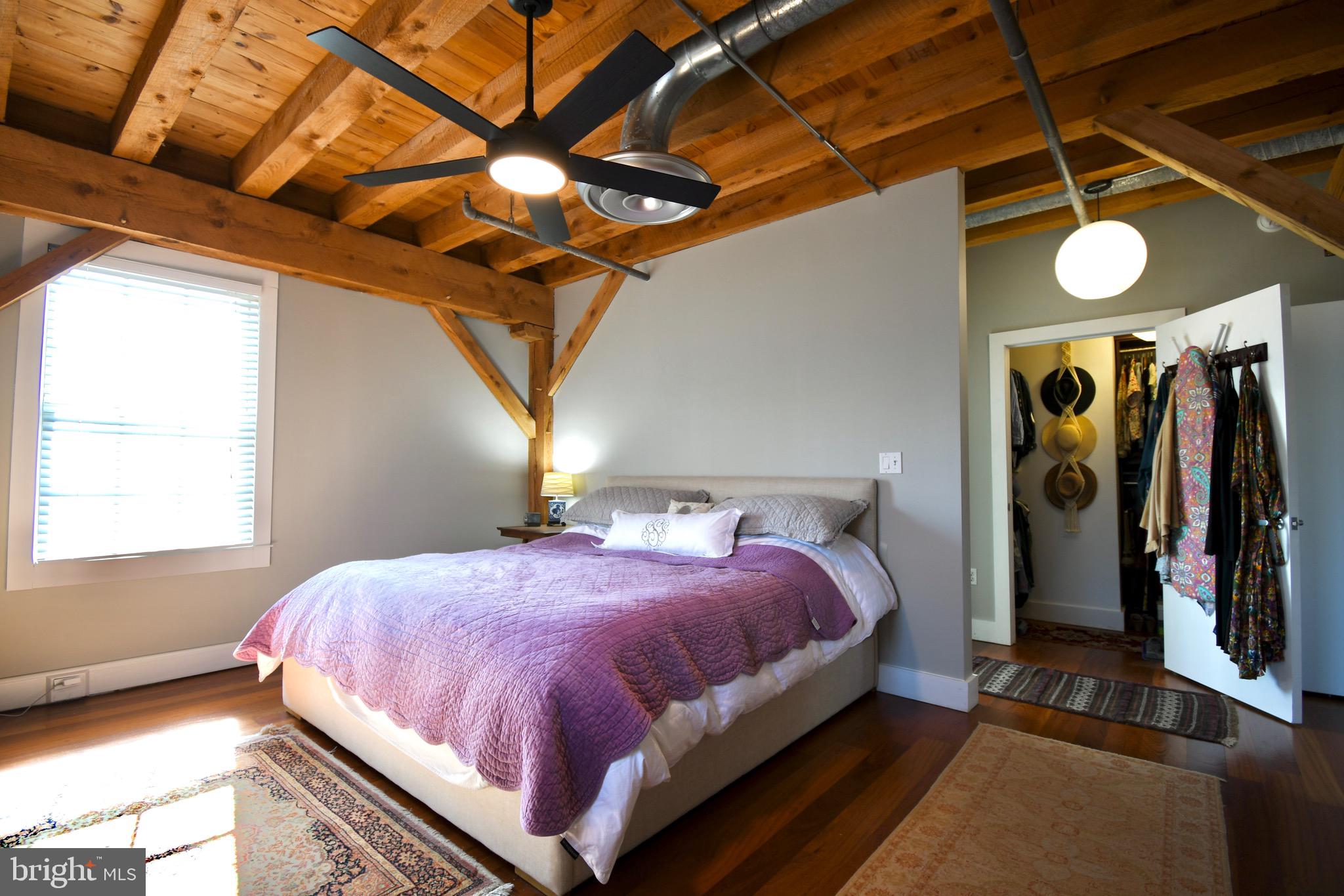26 East Lancaster Avenue, Unit R3 Downingtown, PA 19335 - Photo 12 of 25 a bedroom with a bed and a chandelier
