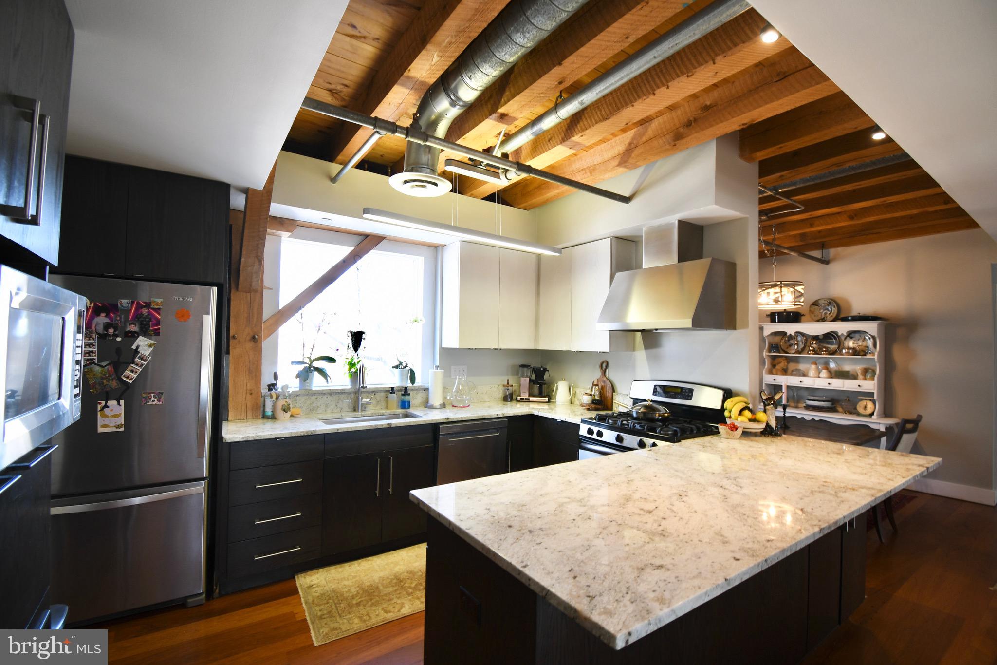 26 East Lancaster Avenue, Unit R3 Downingtown, PA 19335 - Photo 8 of 25 a kitchen with stainless steel appliances granite countertop a sink stove and refrigerator