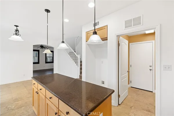 a kitchen with a sink a refrigerator and a stove top oven