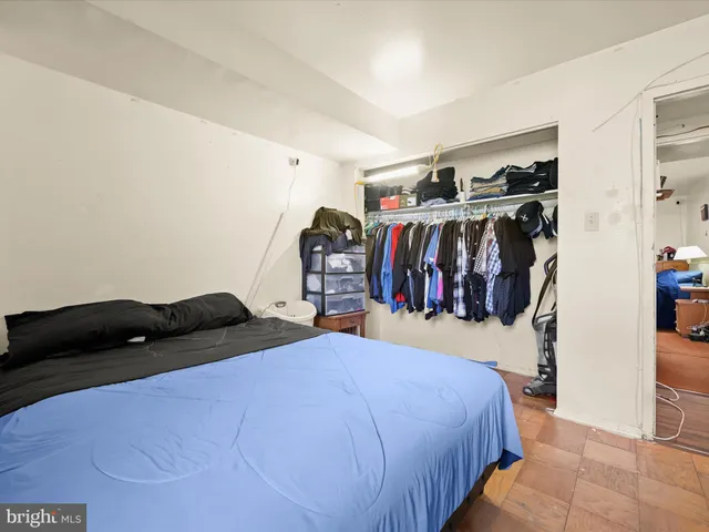 a bedroom with a bed and a closet