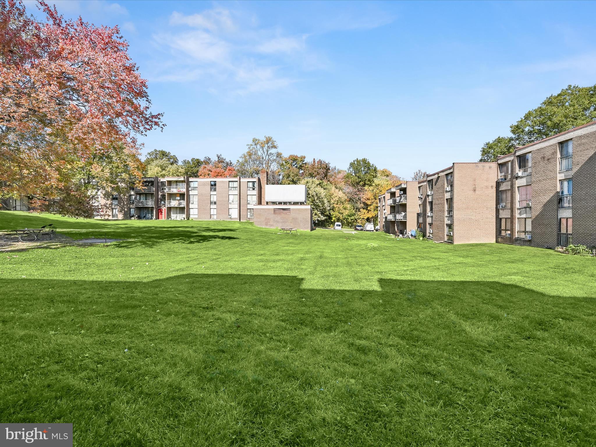 7973 Riggs Road, Unit 2 Hyattsville, MD 20783 - Photo 17 of 21 a view of a building with a big yard and large trees