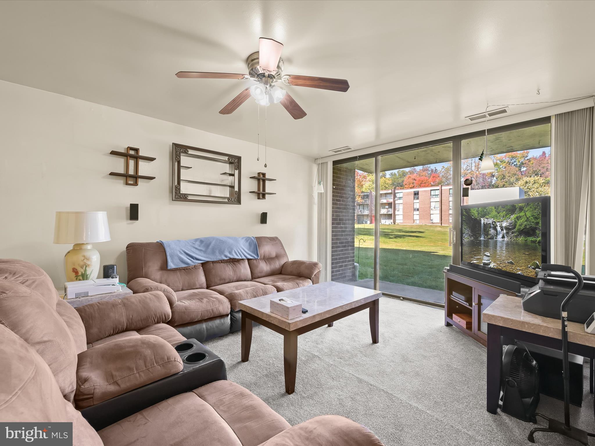 7973 Riggs Road, Unit 2 Hyattsville, MD 20783 - Photo 2 of 21 a living room with furniture a flat screen tv and a window