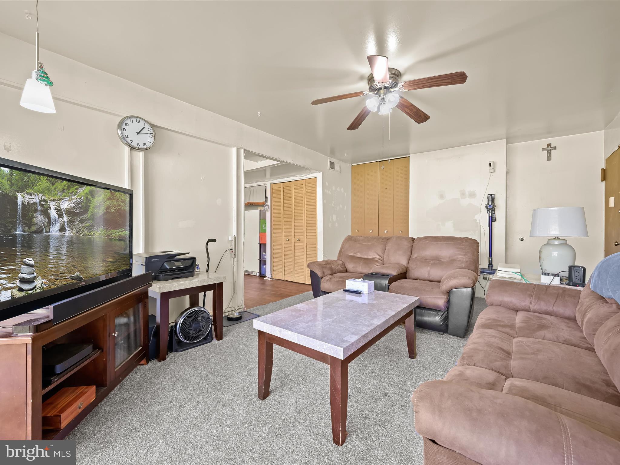 7973 Riggs Road, Unit 2 Hyattsville, MD 20783 - Photo 3 of 21 a living room with furniture a ceiling fan and a flat screen tv