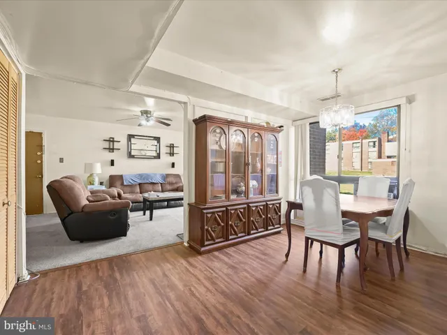 a living room with furniture dining table and a window