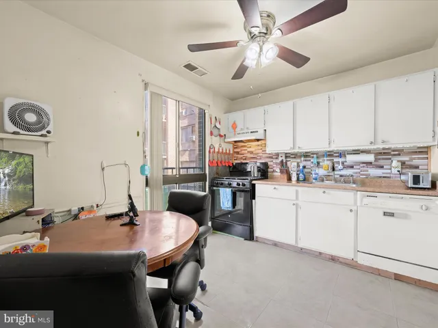 a kitchen with a sink appliances and cabinets