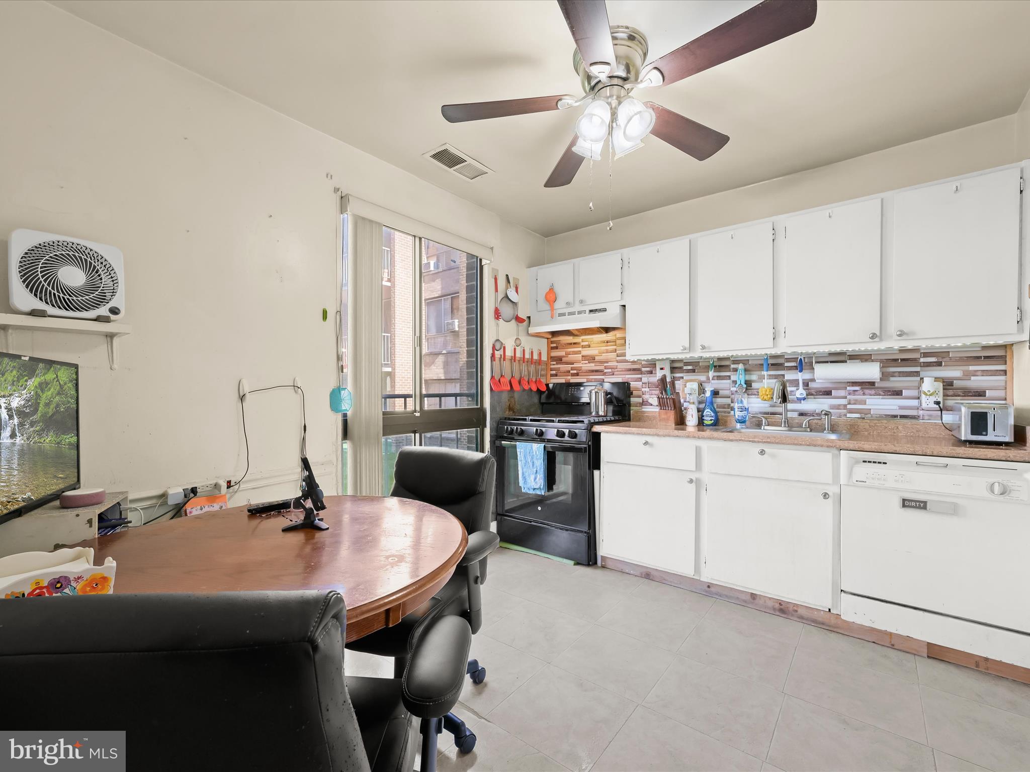 7973 Riggs Road, Unit 2 Hyattsville, MD 20783 - Photo 5 of 21 a kitchen with a sink appliances and cabinets
