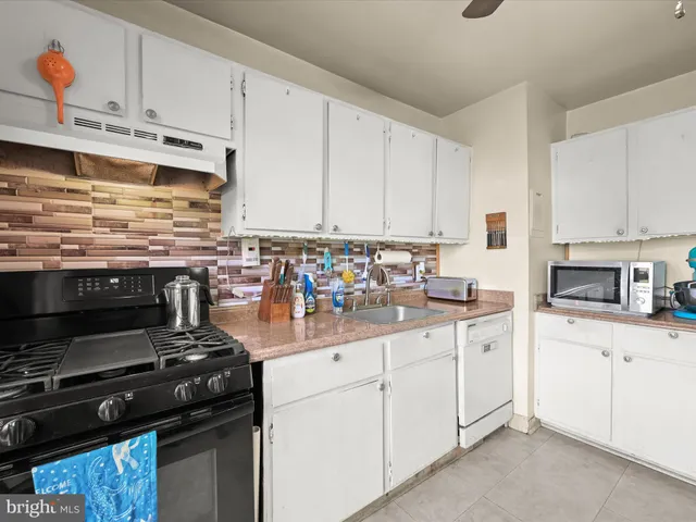 a kitchen with stainless steel appliances and white cabinets