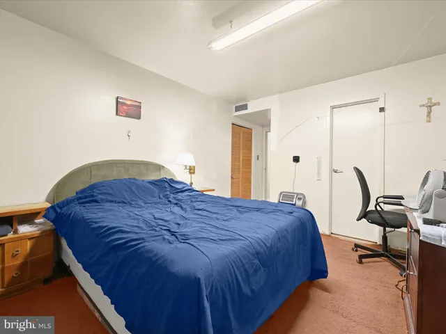 a bedroom with bed and chair