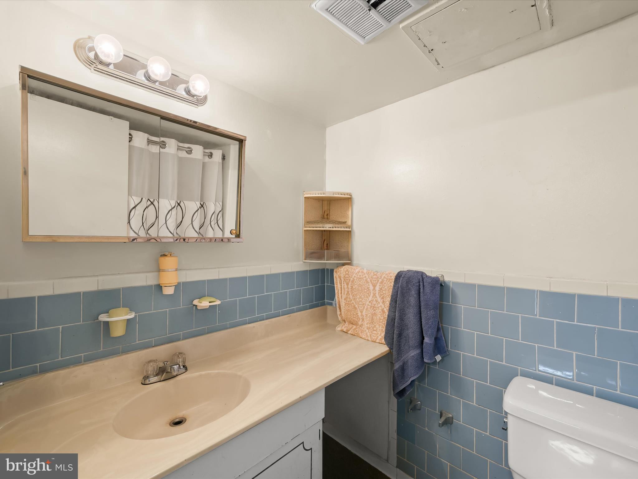 7973 Riggs Road, Unit 2 Hyattsville, MD 20783 - Photo 10 of 21 a bathroom with a sink mirror vanity and toilet