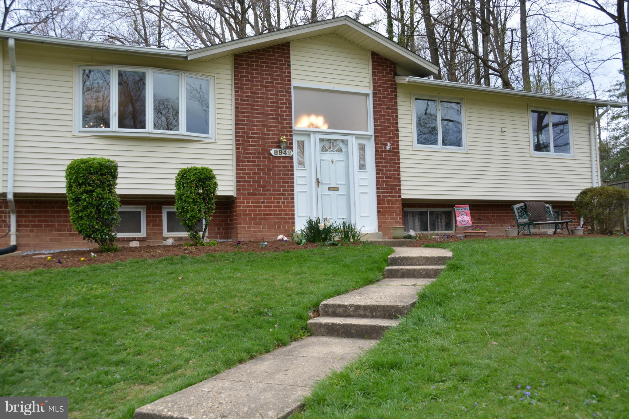 a view of house with a yard