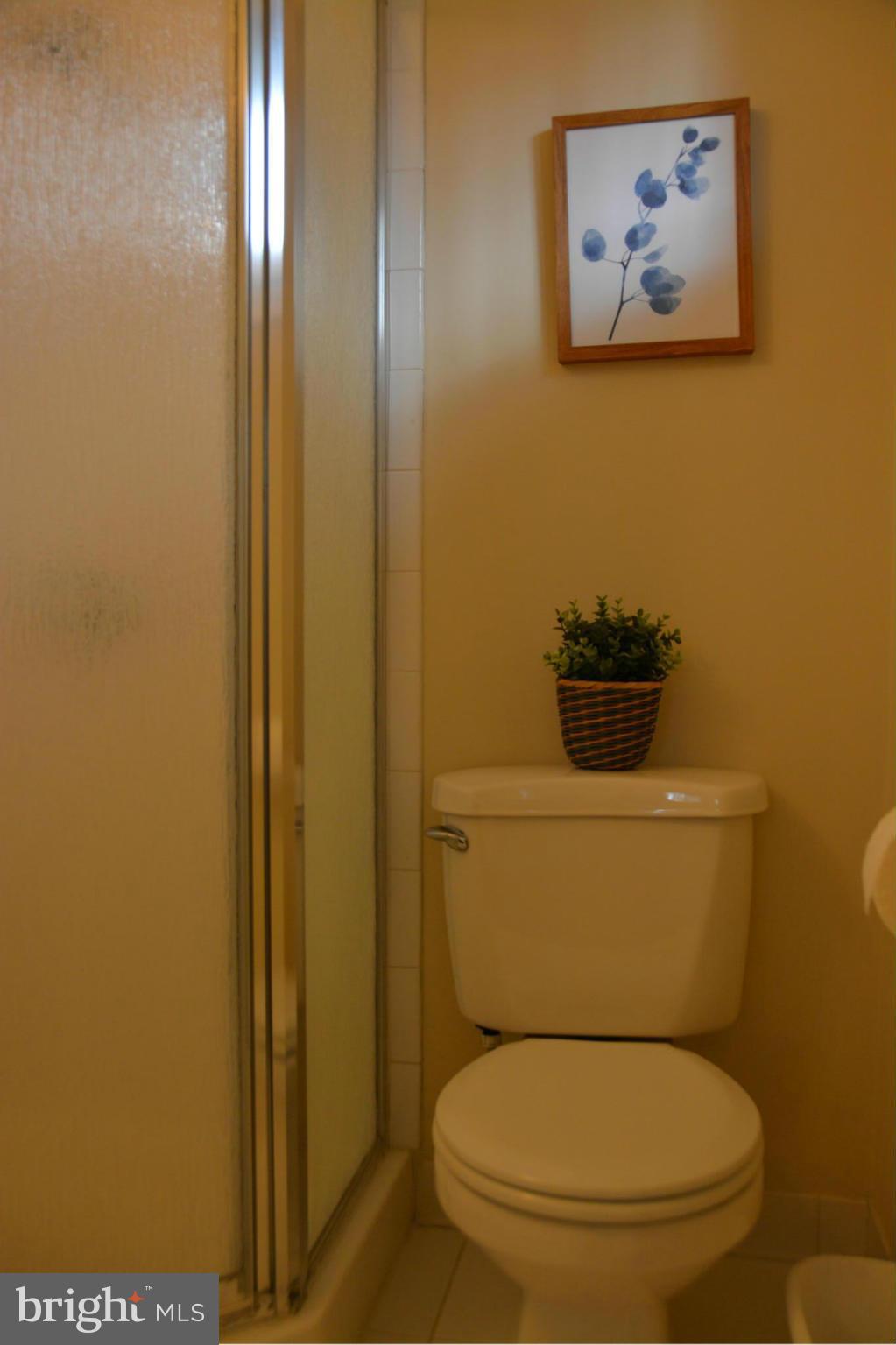 8942 Victoria Road Springfield, VA 22151 - Photo 16 of 25 a white toilet sitting next to a bathroom sink
