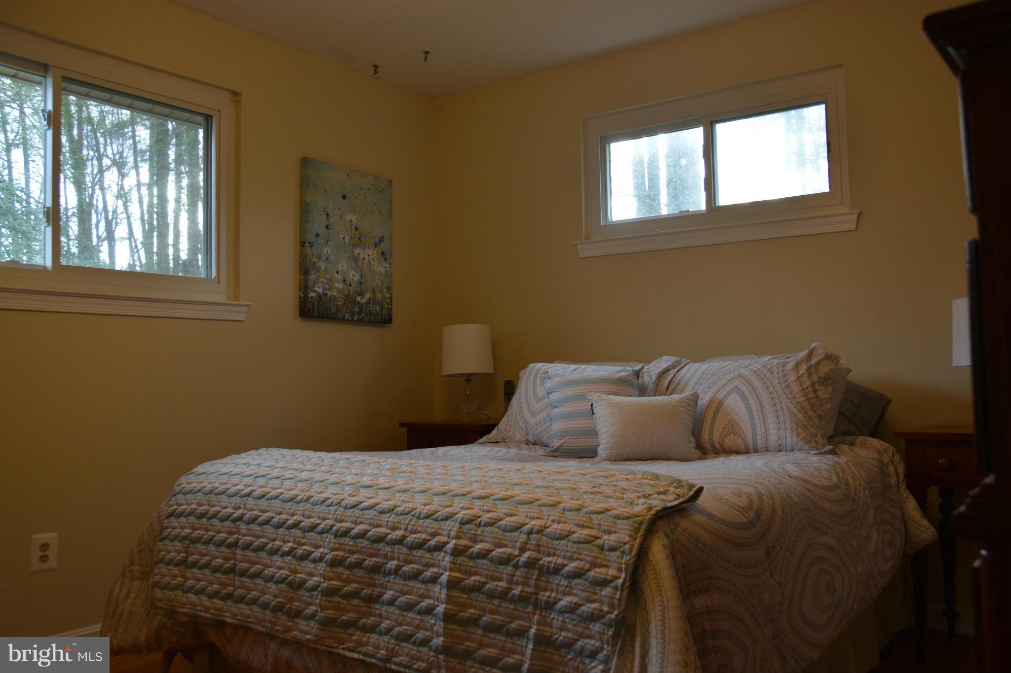 8942 Victoria Road Springfield, VA 22151 - Photo 17 of 25 a bedroom with a bed and a window