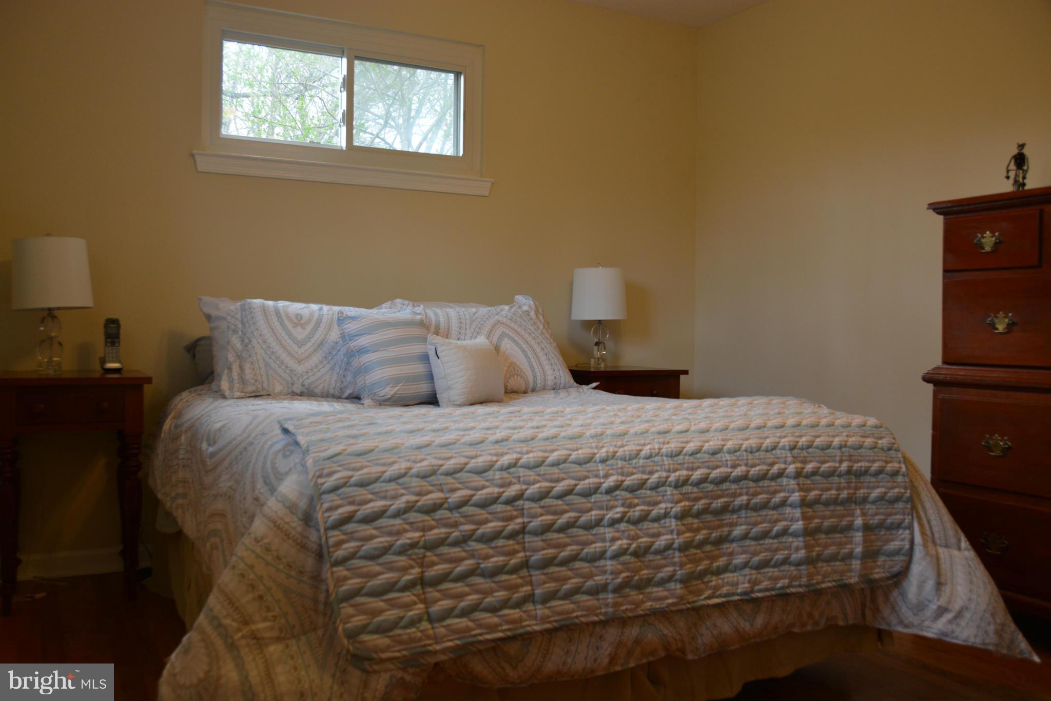 8942 Victoria Road Springfield, VA 22151 - Photo 18 of 25 a bedroom with a bed and wooden floor