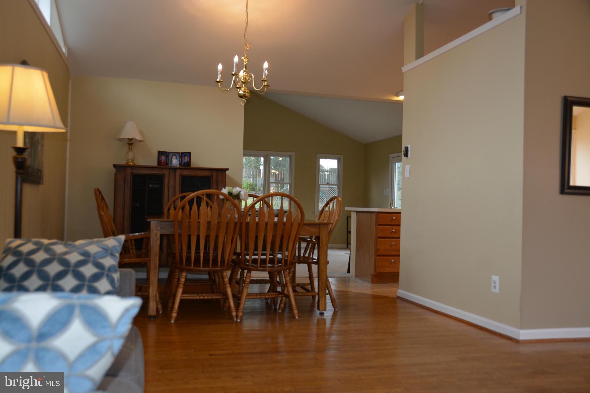 8942 Victoria Road Springfield, VA 22151 - Photo 2 of 25 a view of a dining room with furniture and chandelier