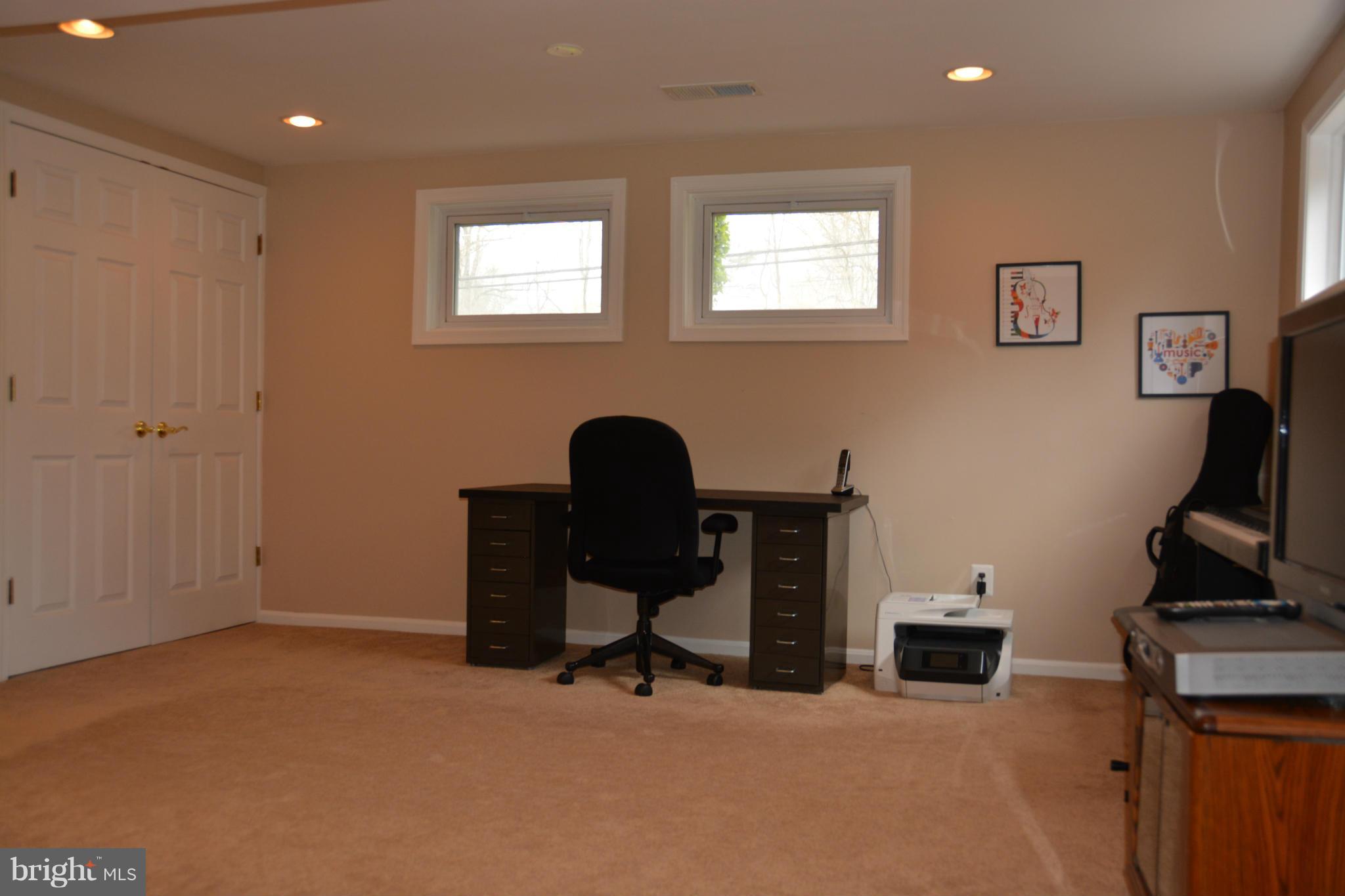 8942 Victoria Road Springfield, VA 22151 - Photo 20 of 25 a view of a workspace with furniture and a window