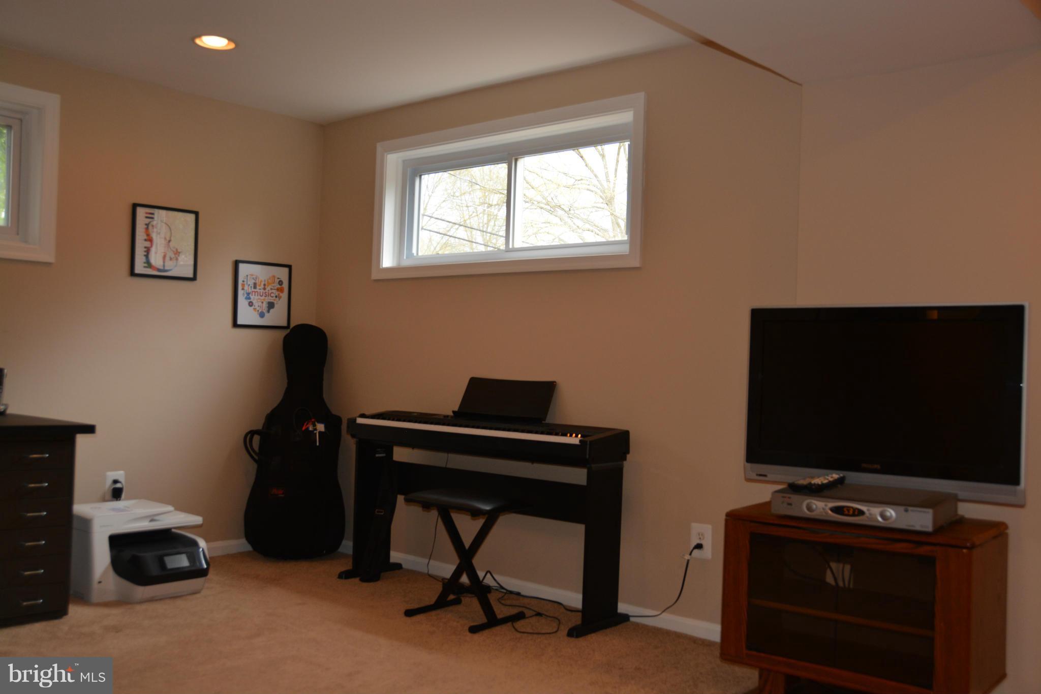 8942 Victoria Road Springfield, VA 22151 - Photo 21 of 25 a view of a workspace with furniture and a window