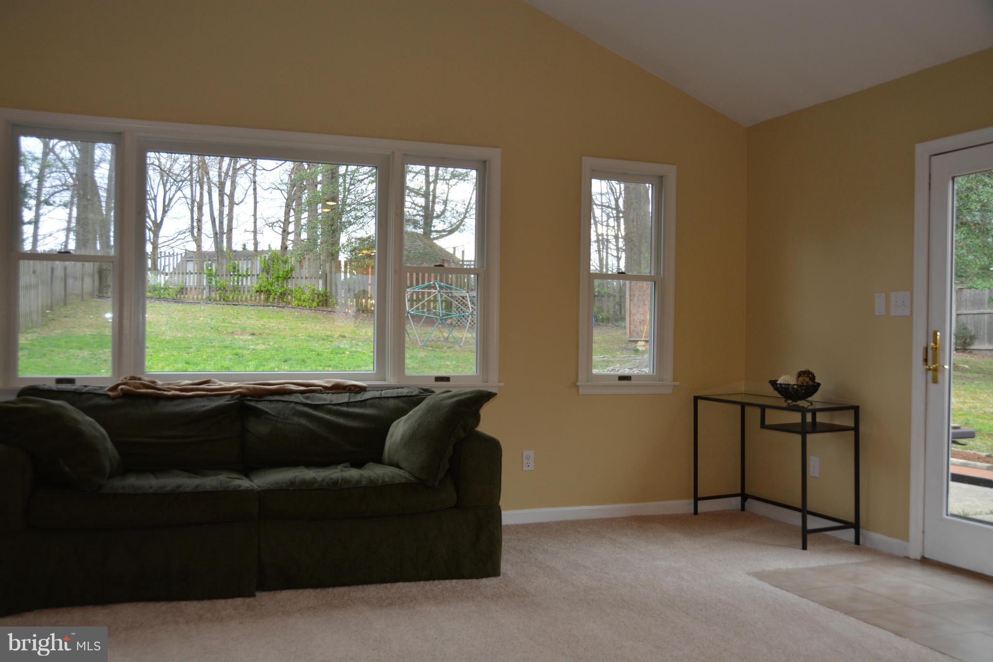 8942 Victoria Road Springfield, VA 22151 - Photo 4 of 25 a living room with furniture and a floor to ceiling window