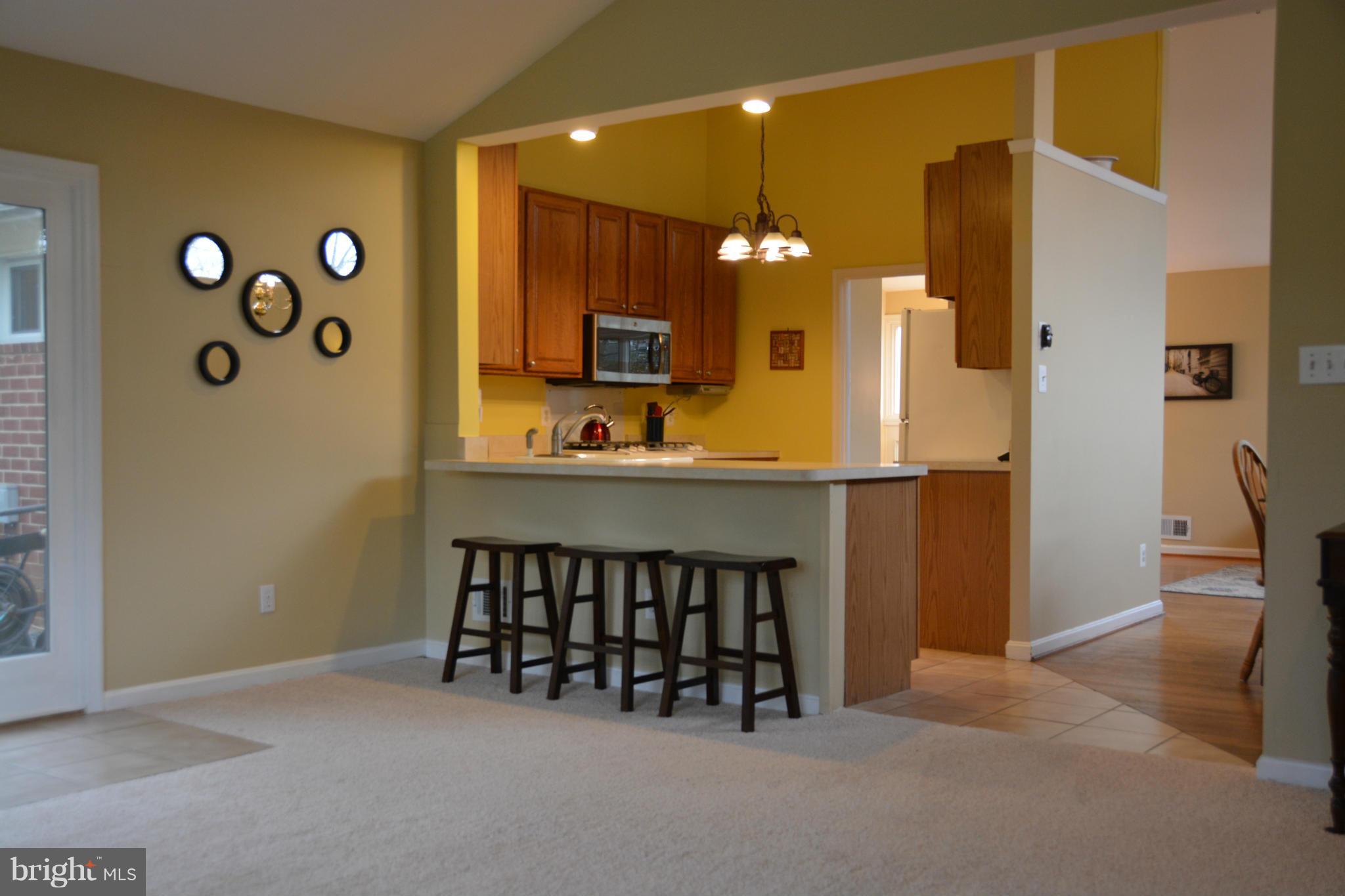 8942 Victoria Road Springfield, VA 22151 - Photo 7 of 25 a view of kitchen with furniture and a refrigerator