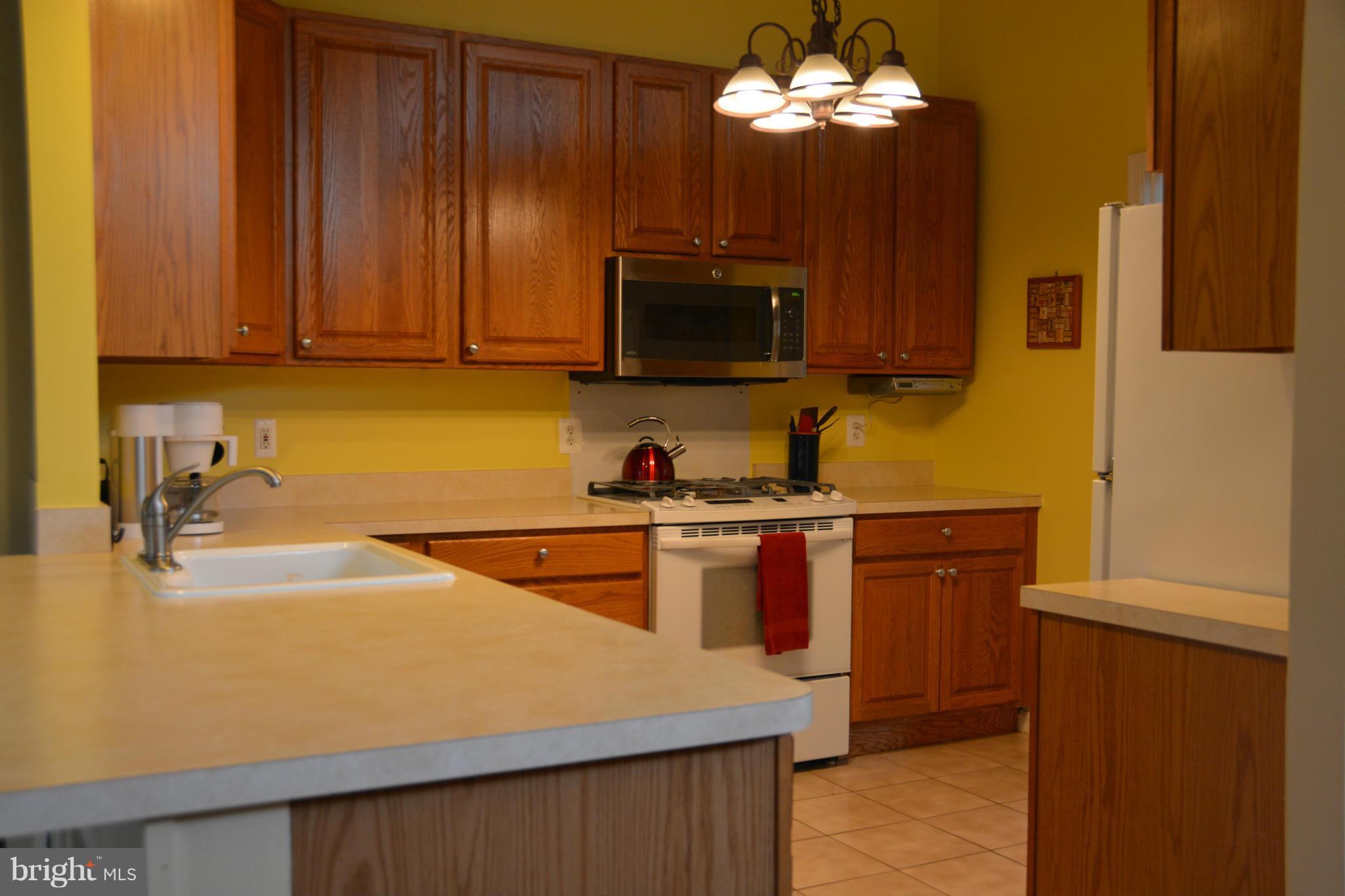 8942 Victoria Road Springfield, VA 22151 - Photo 9 of 25 a kitchen with a sink cabinets and stainless steel appliances