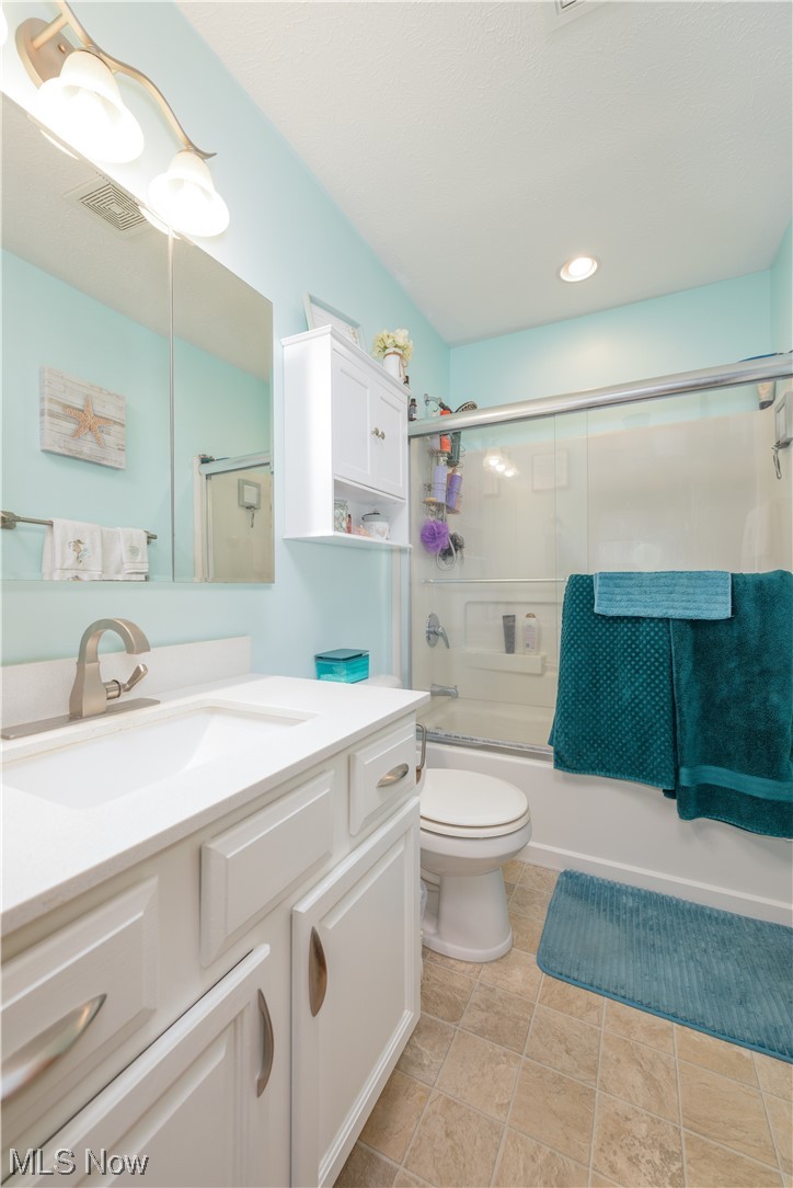 8646 Yale Road Rootstown, OH 44272 - Photo 14 of 30 Full bathroom with toilet, tile flooring, oversized vanity, and shower / bath combination with glass door