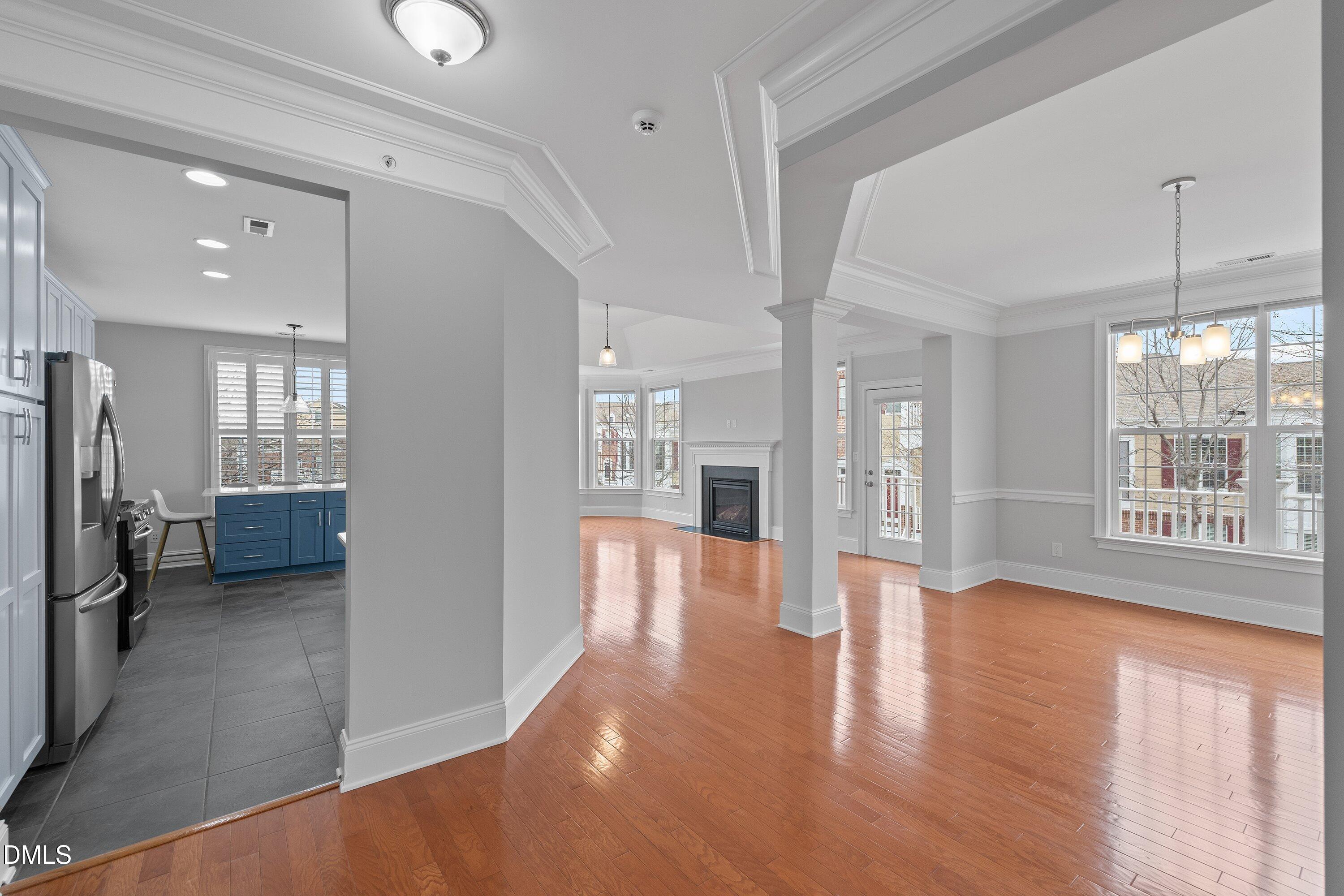 9211 Calabria Drive, Unit 205 Raleigh, NC 27617 - Photo 4 of 55 a view of a big room with wooden floor and a kitchen