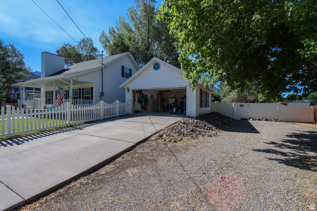 270 East 100 North Monroe, UT 84754 - Photo 6 of 65 White siding exterior with a covered front porch and a detached two-car garage