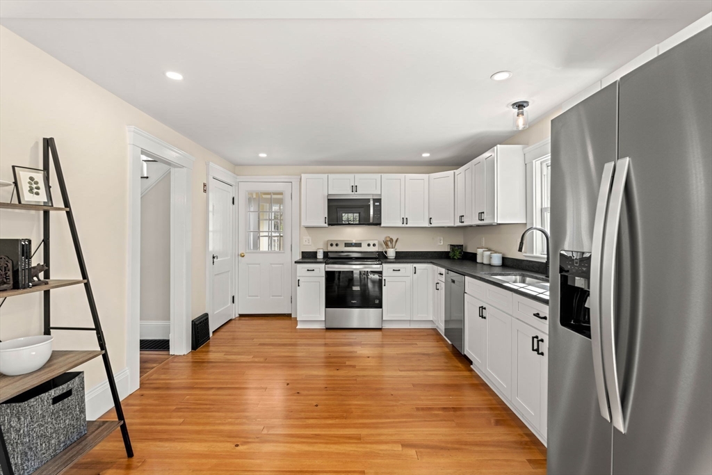 15 Middle Road Amesbury, MA 01913 - Photo 3 of 16 a kitchen with stainless steel appliances a refrigerator and a stove top oven