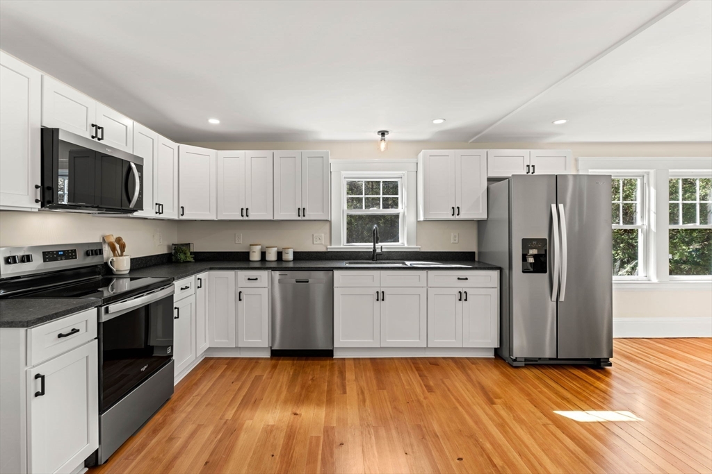 15 Middle Road Amesbury, MA 01913 - Photo 4 of 16 a kitchen with granite countertop a refrigerator stove top oven and sink