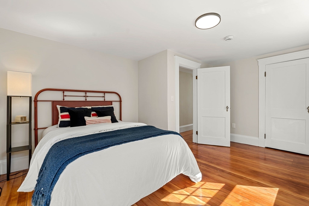 15 Middle Road Amesbury, MA 01913 - Photo 10 of 16 a bedroom with a bed and wooden floor