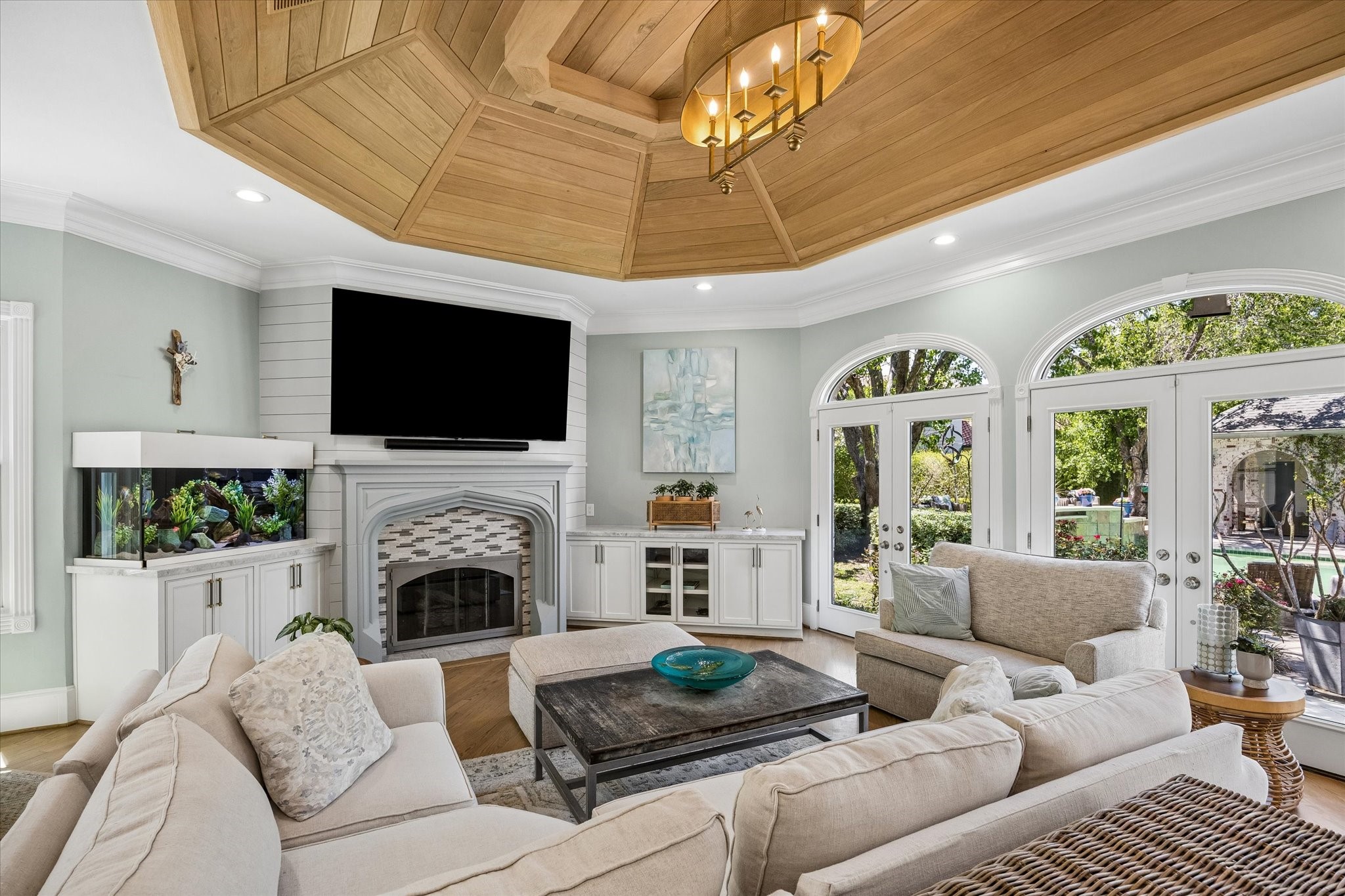 597 Piney Point Road Piney Point Village, TX 77024 - Photo 8 of 39 Inviting family room with views of the outdoors, built ins and fireplace. Notice the ceiling treatment!