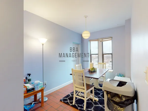 a view of a dining room with furniture and a window