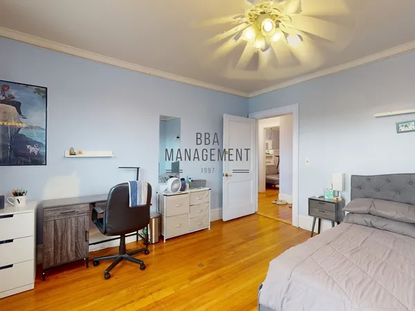 a bedroom with a bed and a chair in it