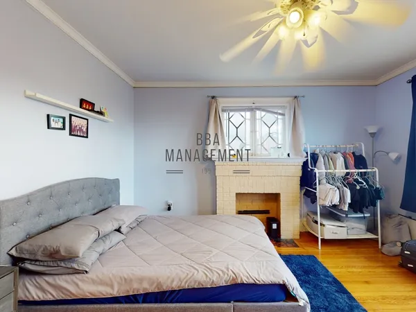 a bedroom with a bed and a fireplace